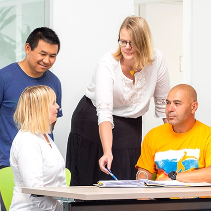 Four employees discussing ideas in a meeting room